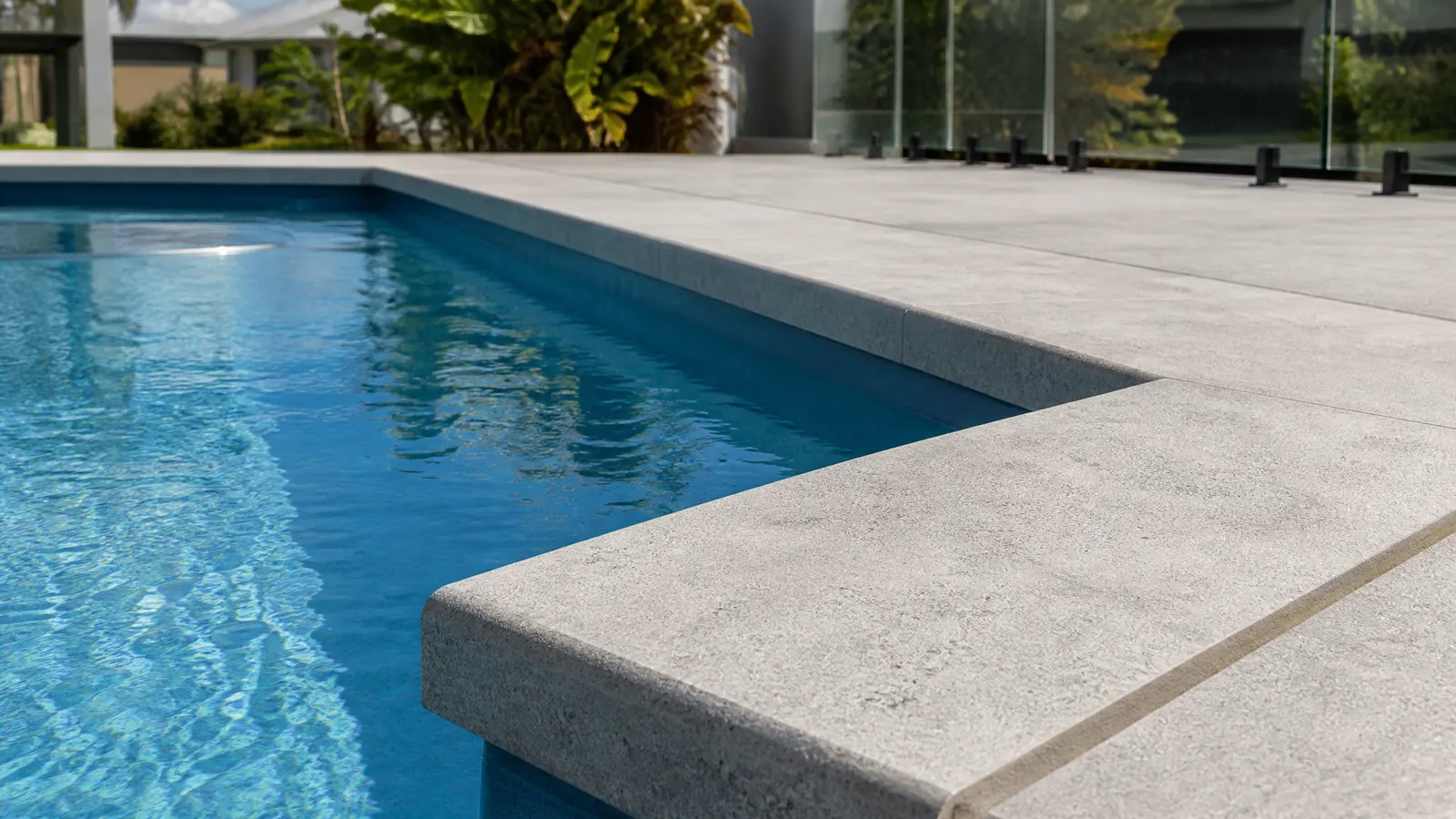 Drop edge pool coping showing elegant shadow line and rebated face on a luxury Gold Coast pool with infinity edge detail
