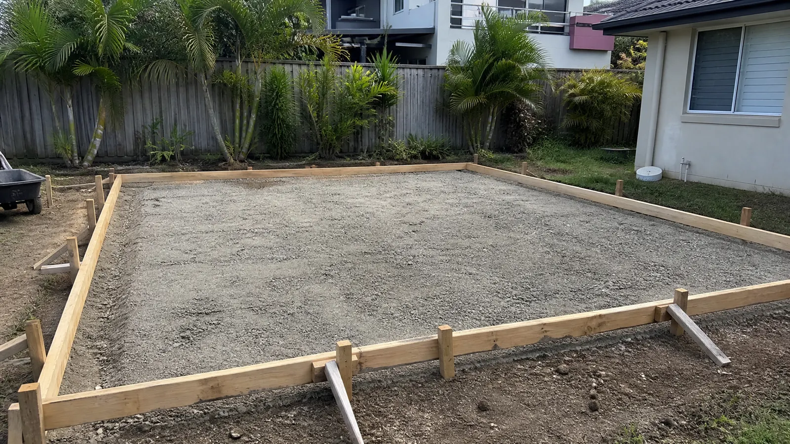 Formwork set up for a concrete shed slab with compacted gravel base and steel reinforcing mesh ready for pouring on Gold Coast