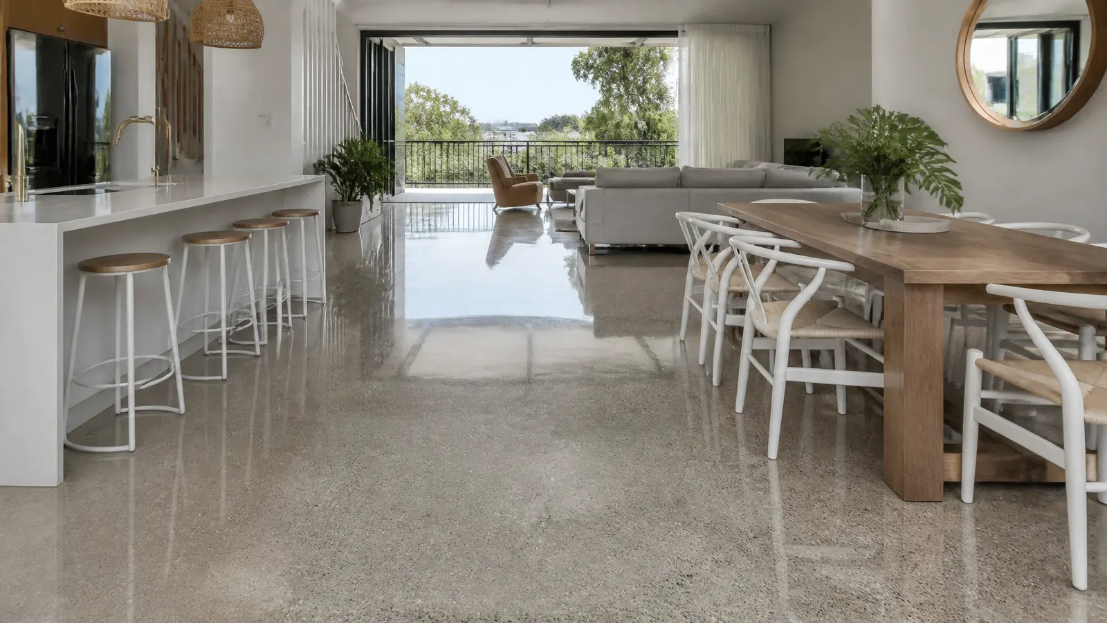Mechanically polished concrete floor with deep reflective gloss showing aggregate pattern in a modern Gold Coast commercial space