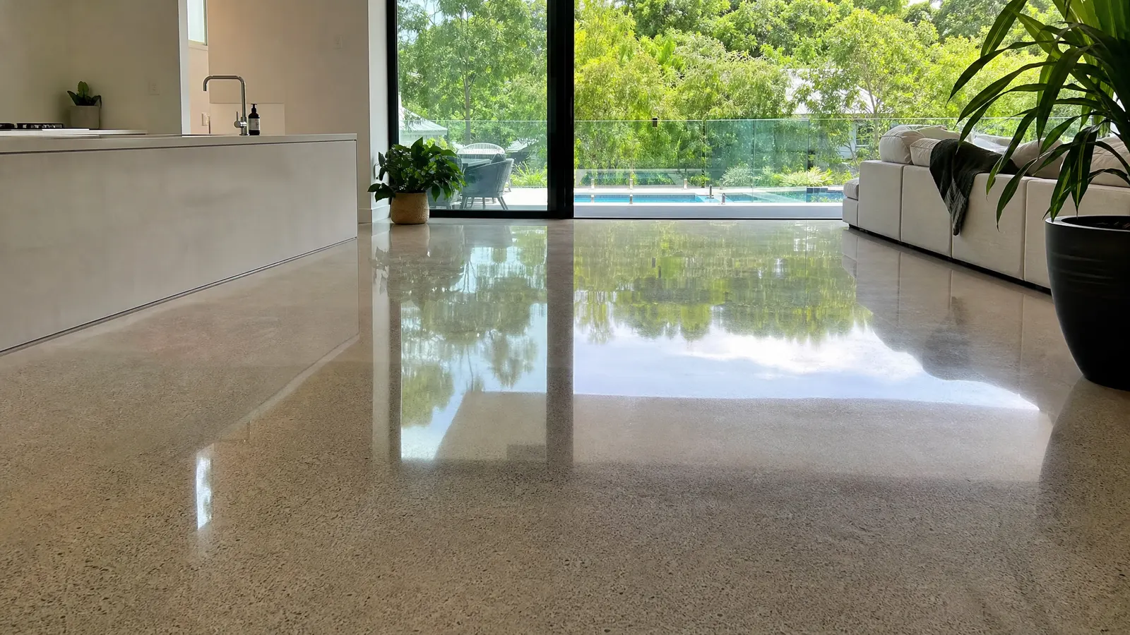 Mechanically polished concrete floor with high gloss reflective finish in a spacious Gold Coast living room with natural light