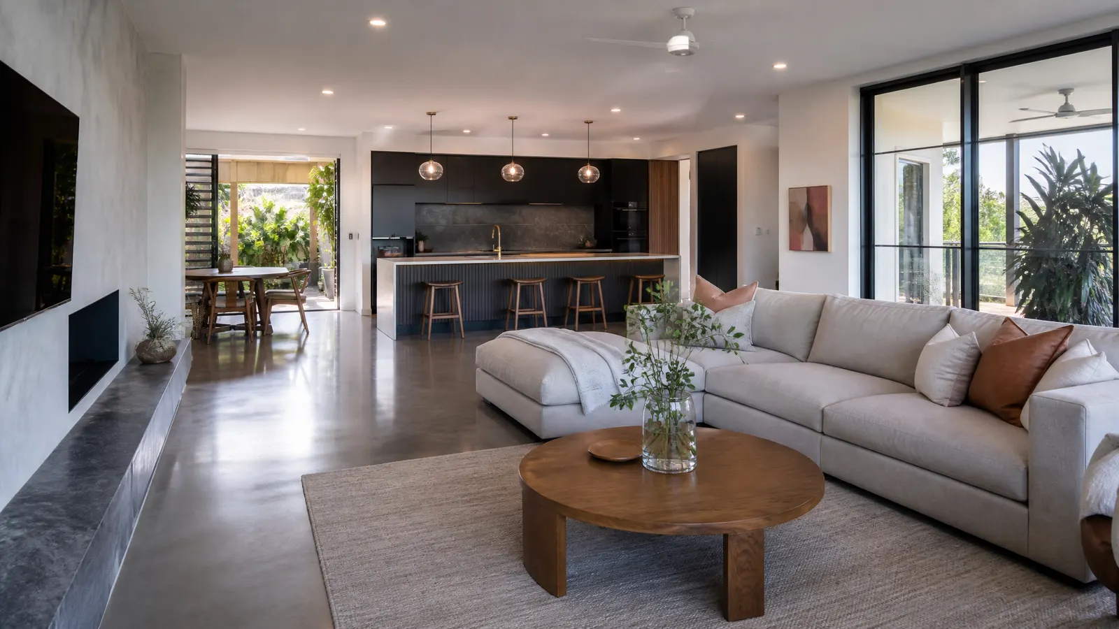 Modern Gold Coast home interior showing polished concrete in living areas transitioning to tiles in the bathroom and kitchen