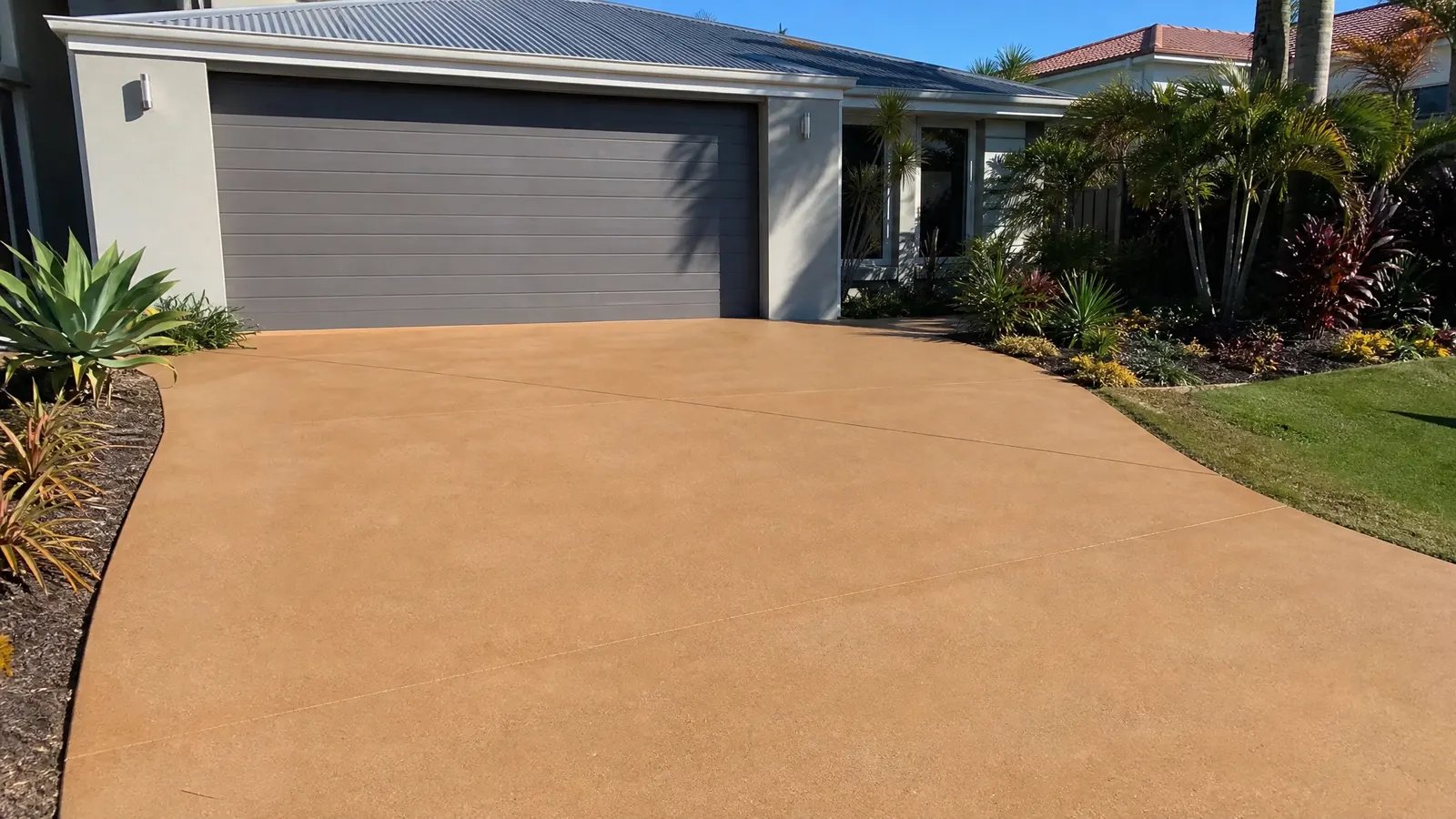 Side by side comparison of coloured concrete smooth finish and exposed aggregate textured finish samples for Gold Coast driveways